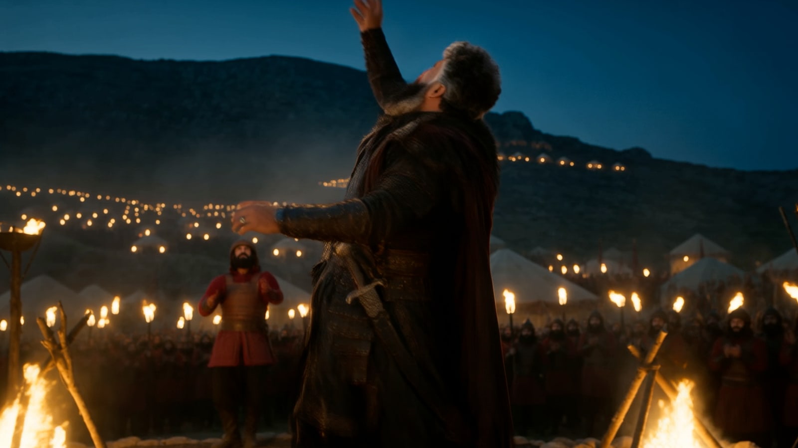 A commander addressing an army by torchlight at night in A True Warrior