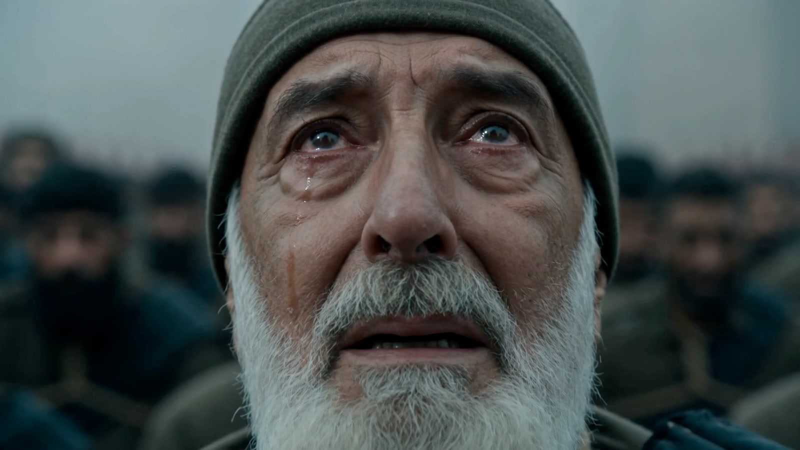 An elderly man in the crowd, close up, in A True Warrior